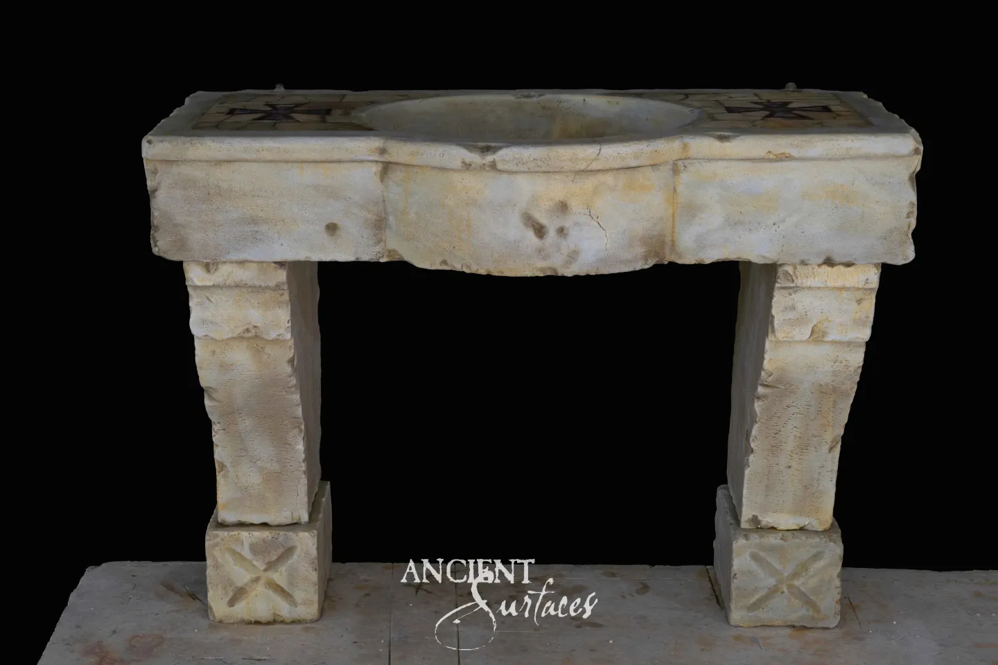 Long reclaimed limestone console sink with a bowed central basin, faint star inlay at the ends and plain tapering legs on blocks carved with saltire crosses