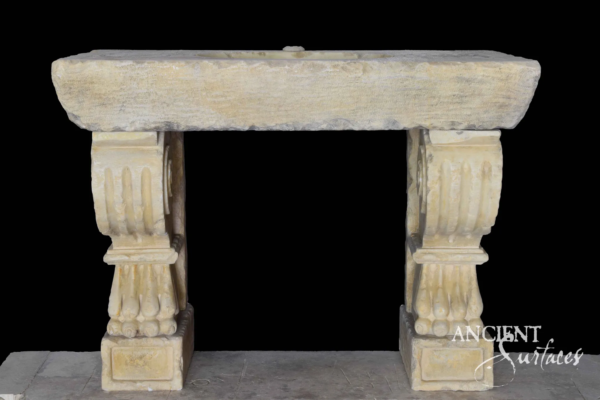 Long plain reclaimed limestone sink slab on two large fluted scroll consoles with carved leaf bands and panelled square plinths